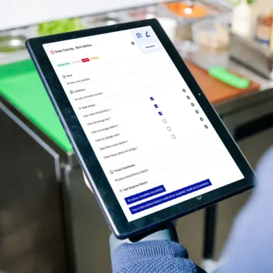 Person holding tablet looking at food stock