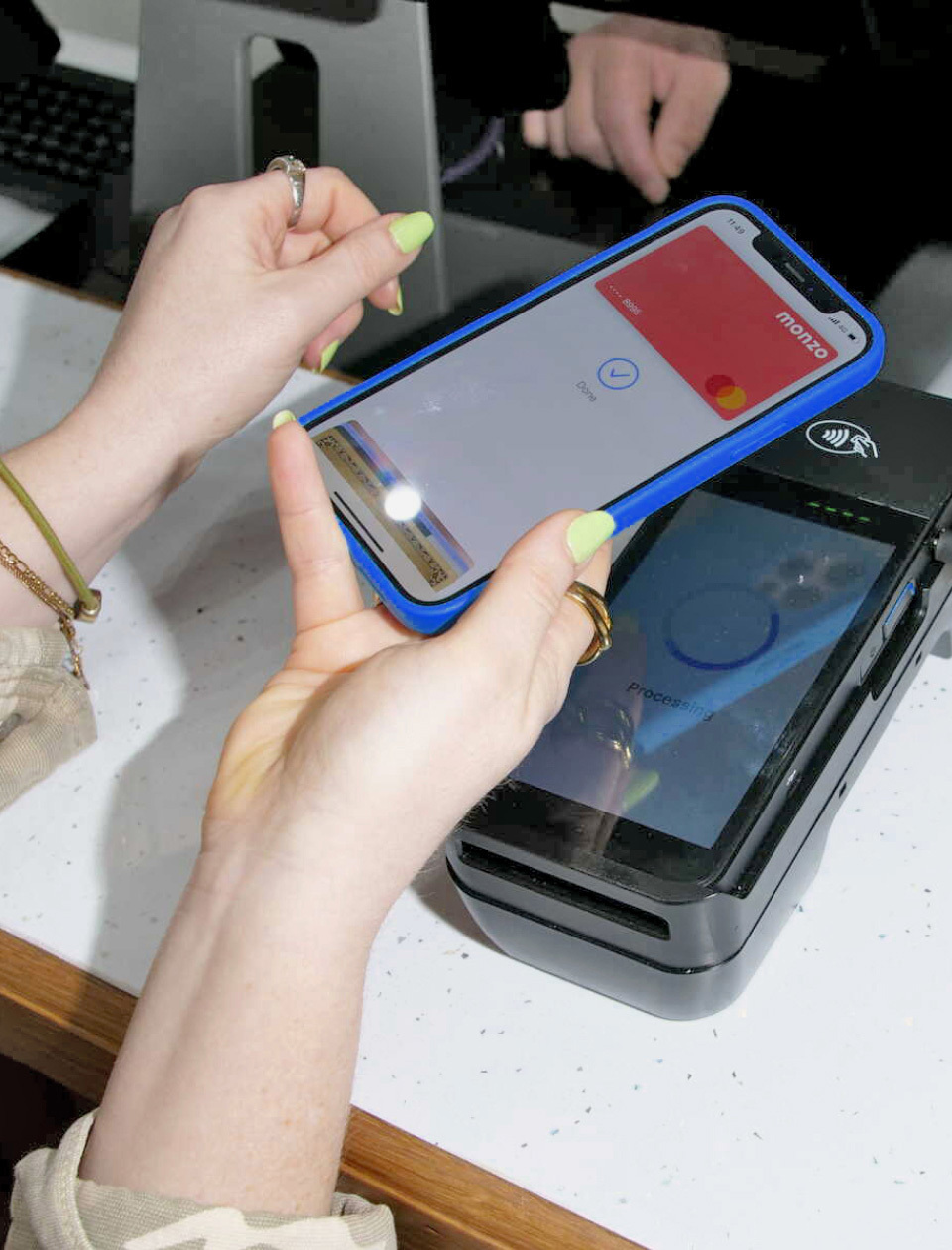Hand holding a bank card over a Flipdish payment device